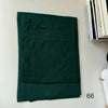 A dark emerald green soft modal rayon hijab set folded neatly on a white surface.