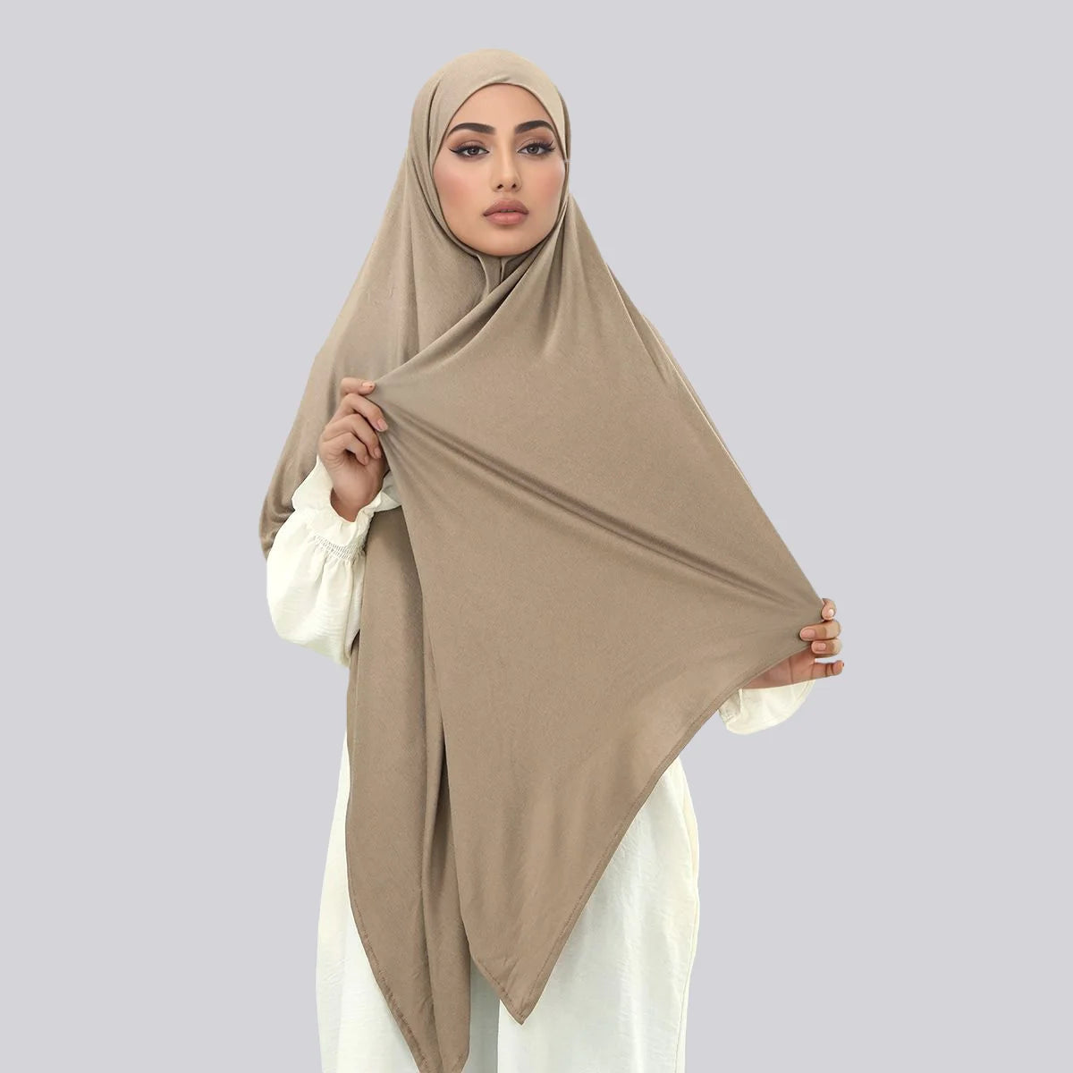 A woman wearing a beige large size stretchy modal square scarf for Islamic wear