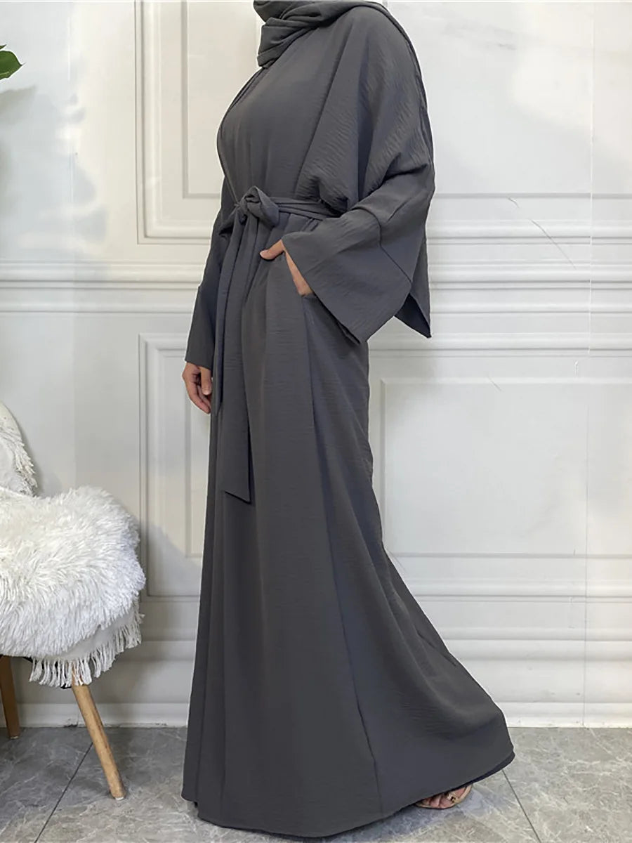 A full-length, charcoal gray elegant women's abaya and kaftan set worn by a model.