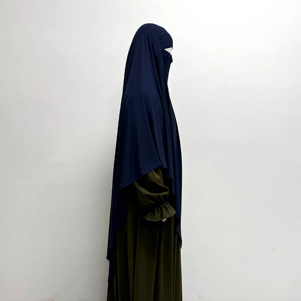 Dunkelblaue atmungsaktive Bambus-Jersey Khimar-Hijab getragen von einer Person vor weißem Hintergrund.