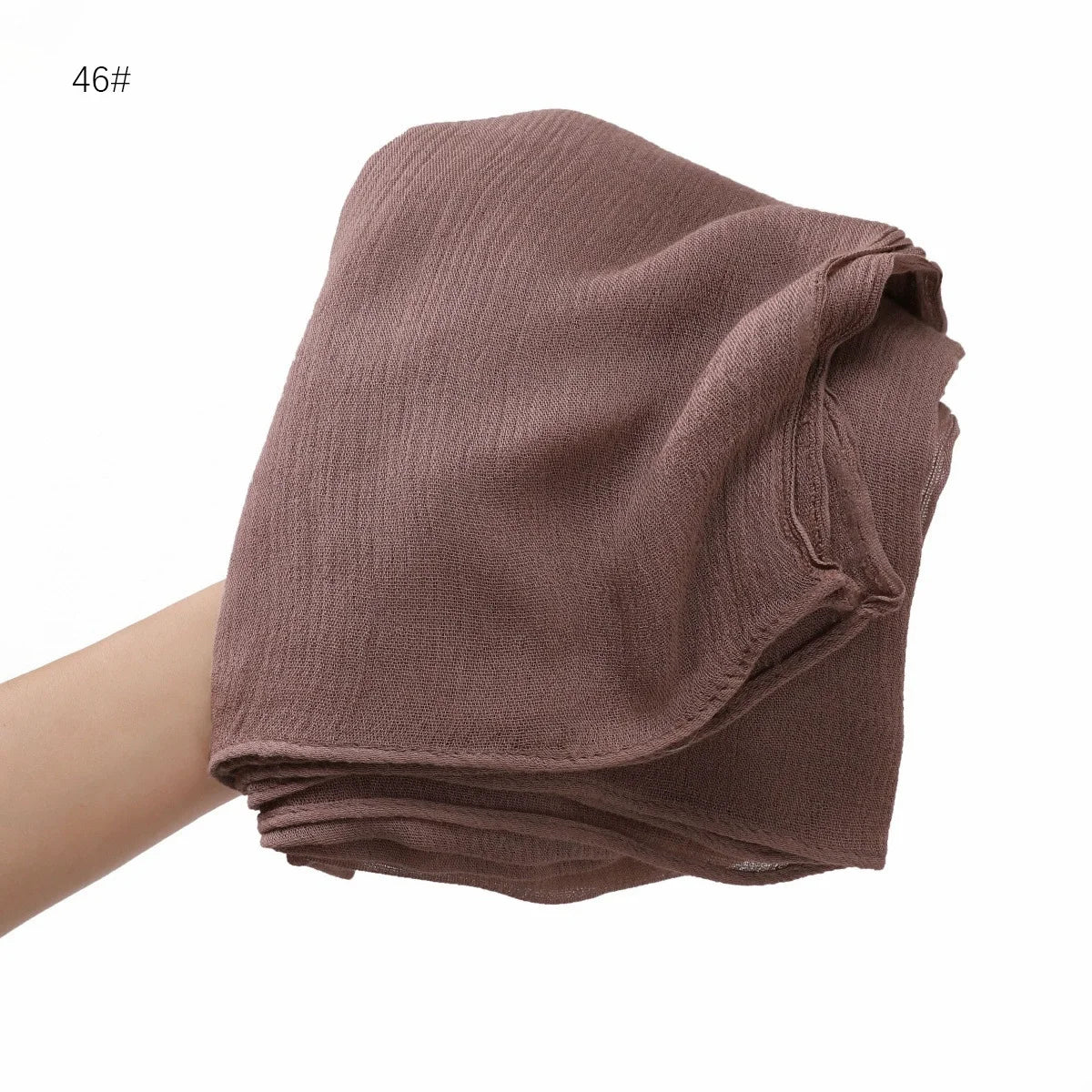 Écharpe châle en crêpe de rayon couleur rose poussière pliée pour femmes.