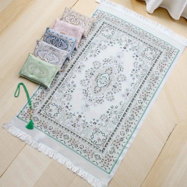 A set of Muslim prayer mats in various shades of pink and green, including a decorative mat with beads and a portable fabric 