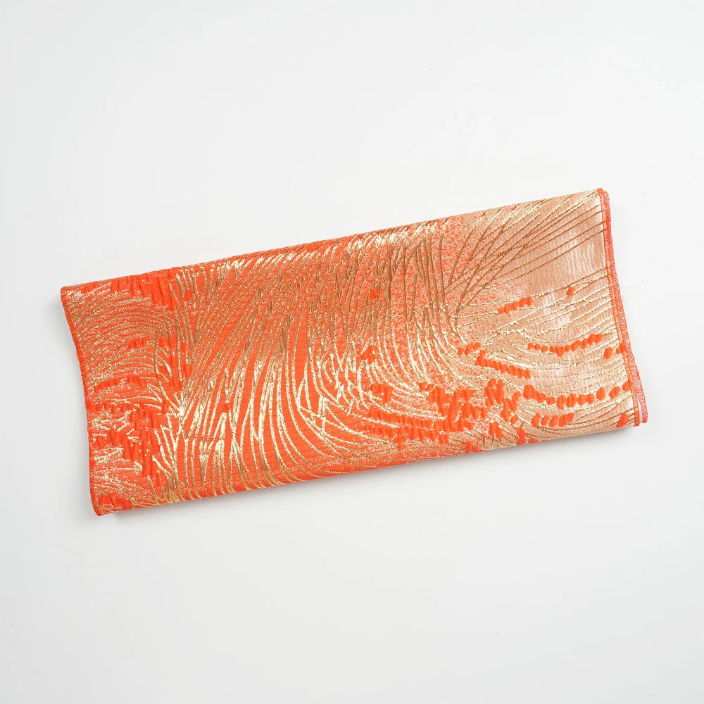 Orange satin kaftan or abaya featuring intricate gold swirling patterns