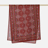 A maroon printed linen hijab scarf hanging on a rod.