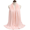 A flowing, pale pink modal jersey hijab draped around a mannequin's neck and shoulders.