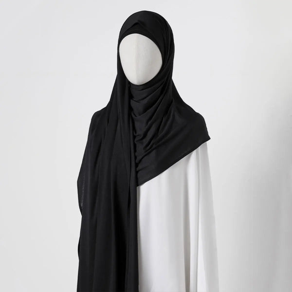 Black chiffon shawl draped over a mannequin's shoulder
