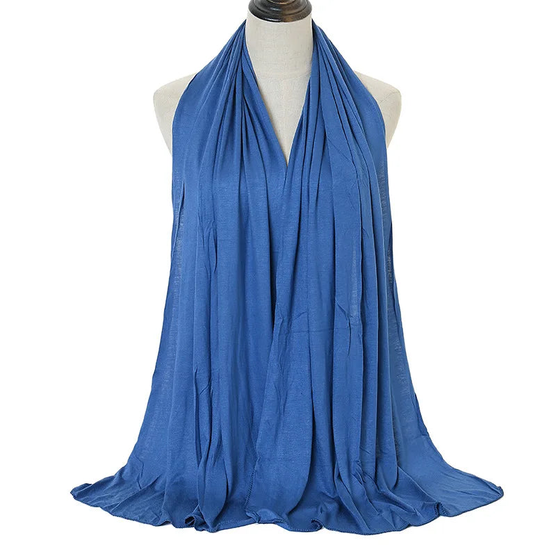 A royal blue soft modal jersey hijab scarf draped around a mannequin's neck.