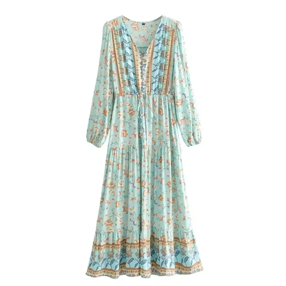 A light blue boho floral lantern sleeve maxi dress with intricate embroidery and tiered ruffle hem.