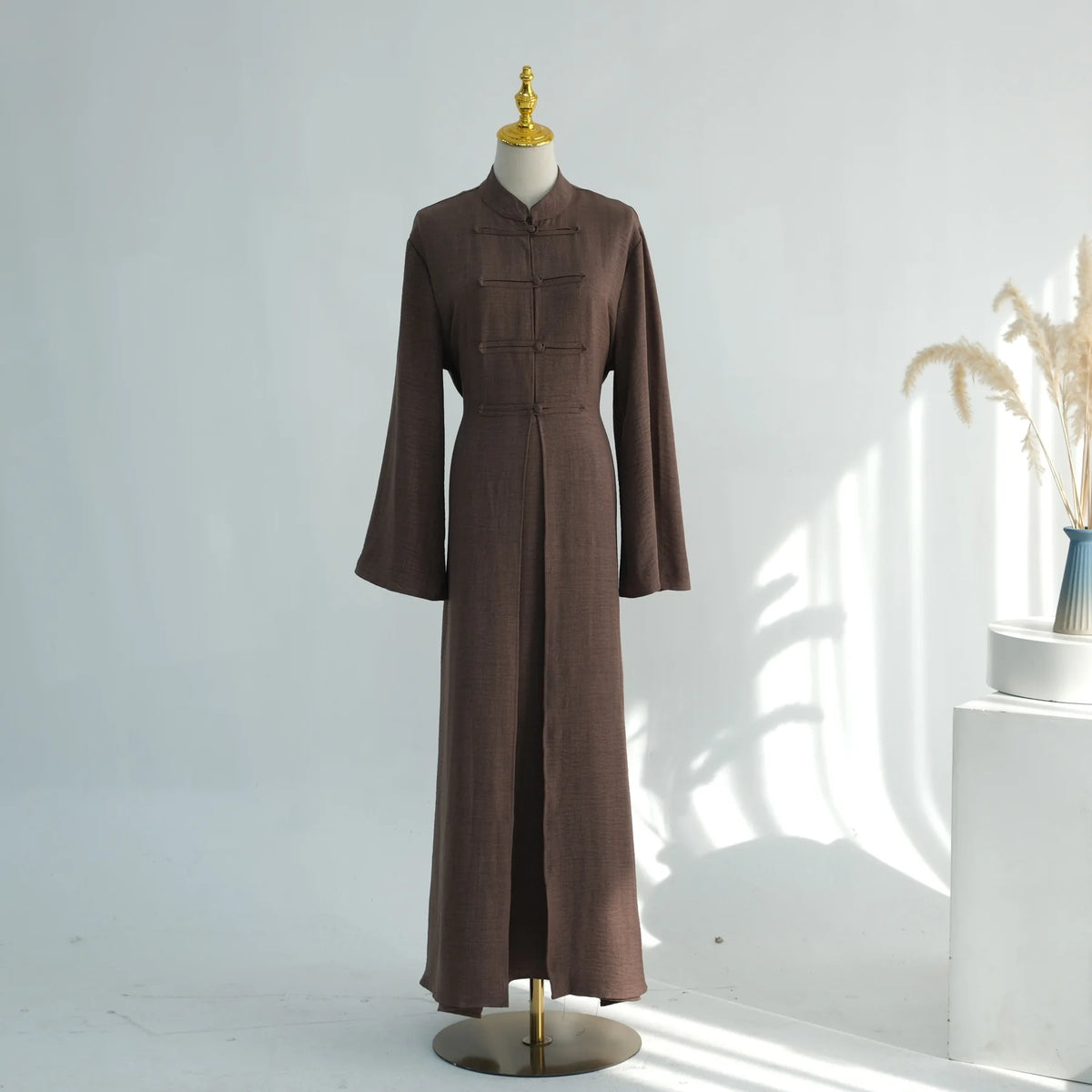 A brown elegant two-piece Arabic modest set displayed on a mannequin.