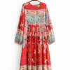 Vestido largo floral rojo con bordado y borlas azules y rosas.