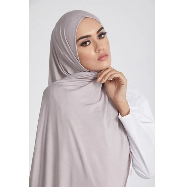 A woman wearing a light mauve premium modal cotton hijab scarf
