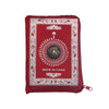 A red portable braided prayer rug featuring a compass design and 'Made in China' text.