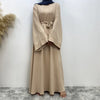 Una elegante abaya de encaje beige para mujeres, mostrada en plano completo.