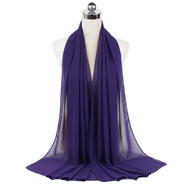 A purple chiffon hijab scarf draped around a mannequin neck.