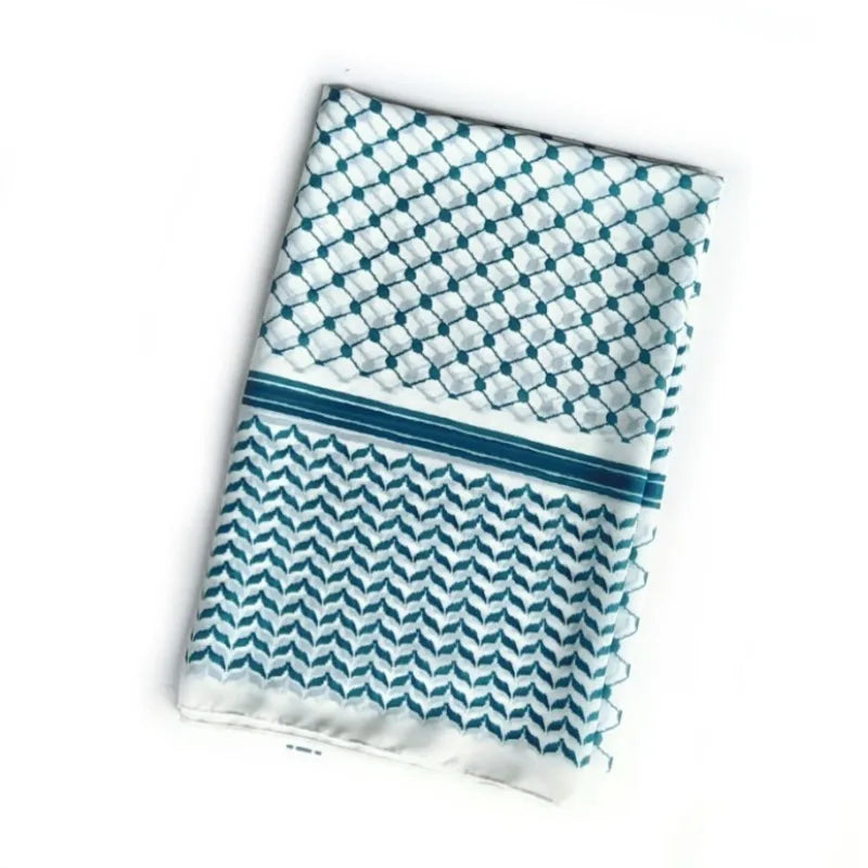 Pañuelo hiyab de chifón elegante doblado con patrón geométrico blanco y turquesa.