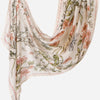 A flowing, light beige linen hijab scarf featuring a delicate floral print of pink and green foliage.