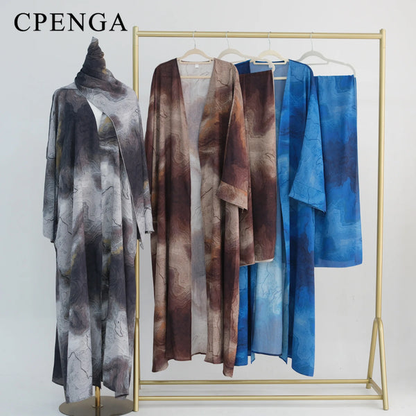 A display of an elegant floral abaya and hijab set featuring various shades of blue, brown, and gray fabric.