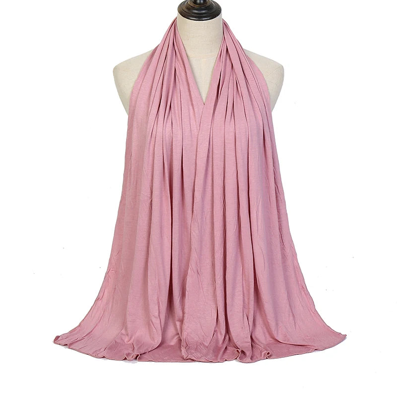 A flowing mauve soft modal jersey hijab scarf draped around a mannequin's neck.