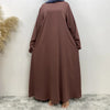 Una abaya larga y fluida color granate para mujeres, hecha de elegante tela de encaje.