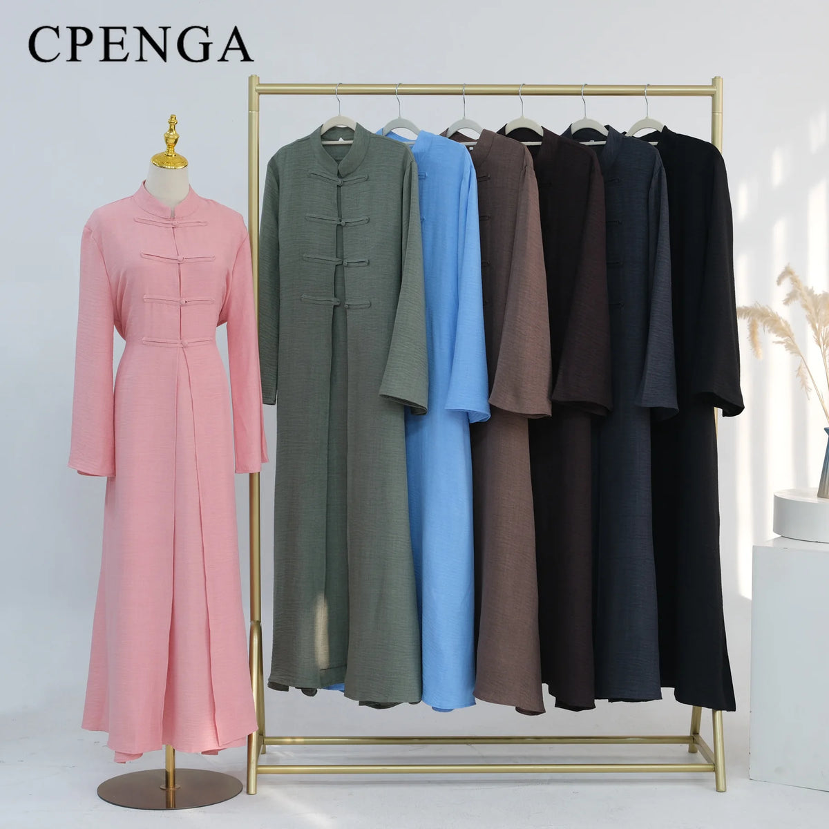 A display of an elegant two-piece Arabic modest set featuring long, flowing dresses in shades of pink, green, and blue.