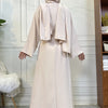 A woman wearing a beige elegant abaya and kaftan set, shown from the back.