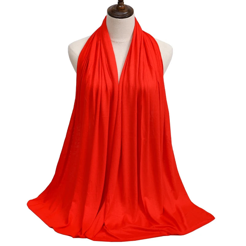 A vibrant red premium modal jersey hijab draped around a mannequin's neck.