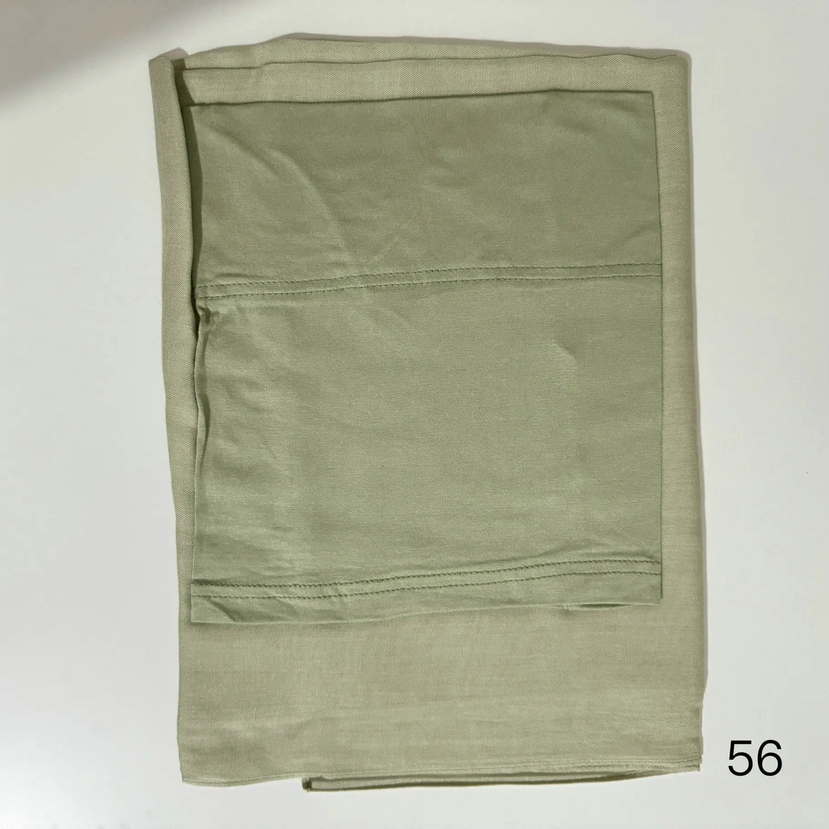 A folded light olive green soft modal rayon hijab set for women.