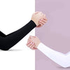 A person wearing a black arm sleeve is holding hands with another person wearing a white arm sleeve.