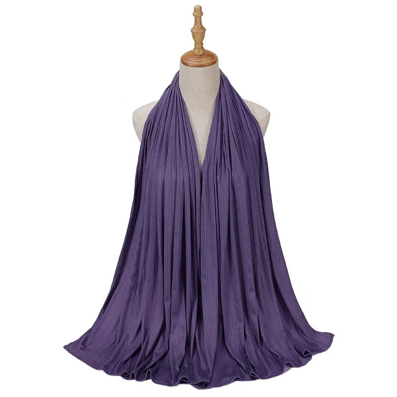 Bufanda de jersey de algodón morado drapeada alrededor del cuello de un maniquí.