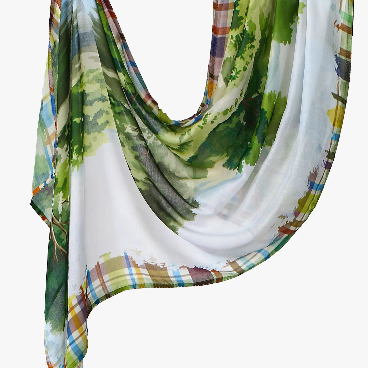 Elegant printed linen hijab scarf featuring a watercolor design of green foliage and plaid patterns.