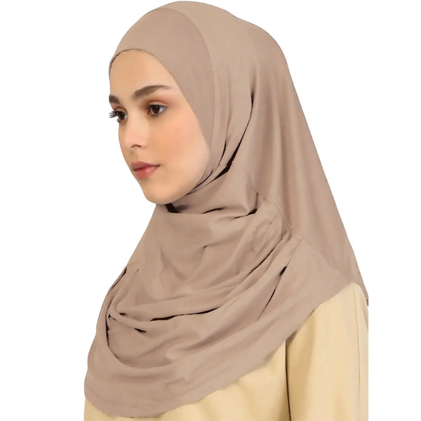 A woman wearing a beige instant ready-to-wear hijab and a cream top.
