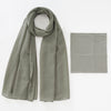 A soft sage green chiffon hijab and underscarf set displayed flat.
