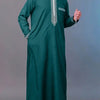 A man wearing a dark green Moroccan ethnic thobe with a stand collar and silver embroidery.