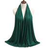 A deep emerald green premium modal jersey hijab draped around a mannequin's neck.