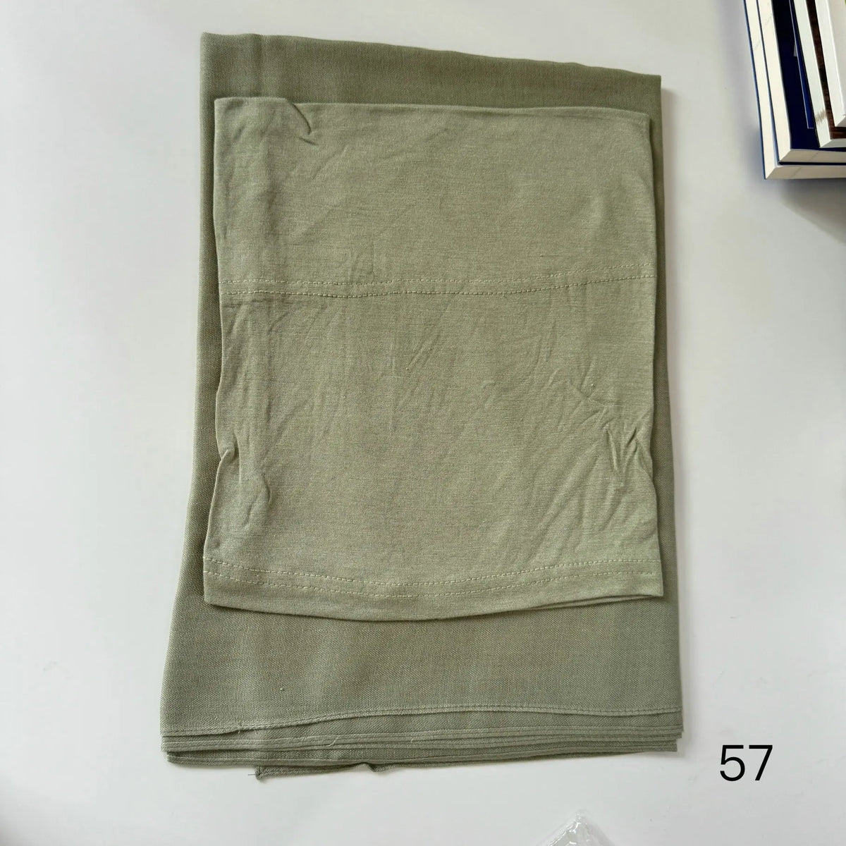A folded olive green soft modal rayon hijab set for women.
