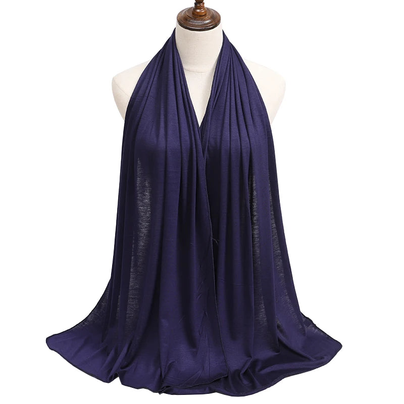 A deep indigo premium modal jersey hijab draped around a mannequin's neck.