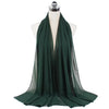 A dark emerald green chiffon hijab scarf draped over a mannequin.