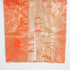 Orange satin kaftan fabric featuring intricate gold embroidery and textured patterns