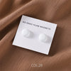 White no-snag hijab magnets on a white card against a brown fabric background