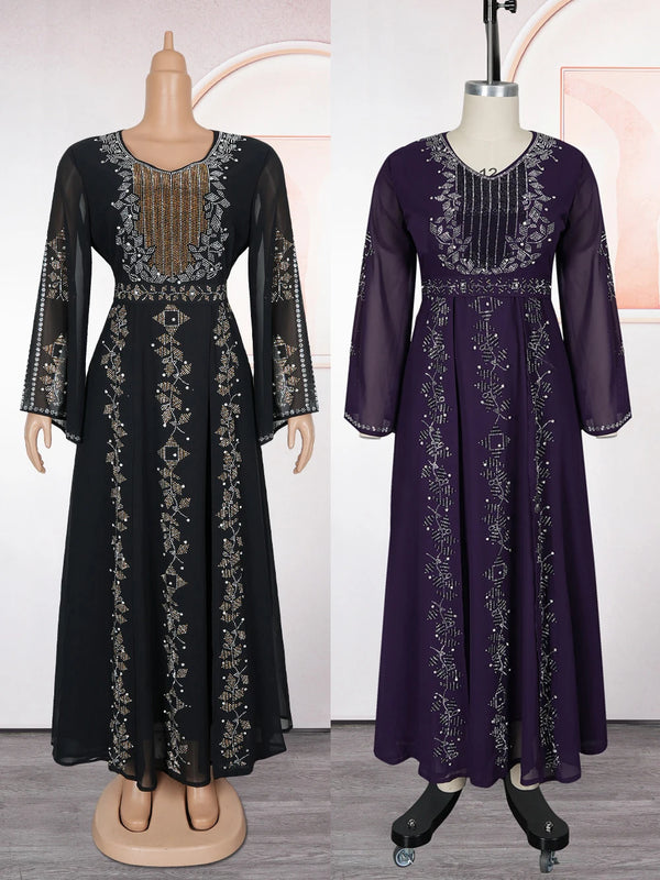 A dark purple chiffon abaya dress with intricate embroidery and ruffle sleeves displayed on a mannequin.