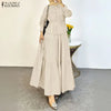 Eine Frau modelliert ein elegantes beige, bedecktes Hemd und einen mehrlagigen Maxi-Rock-Set.