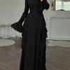 A full-length black maxi dress with a high neckline, long sleeves, and ruffled tiers.