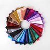 A circular arrangement of solid color silk satin hijab scarves in various shades including pink, purple, gold, and blue.
