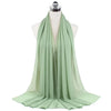 A light sage green chiffon hijab scarf draped on a mannequin.
