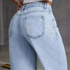 Vista cercana de pantalones vaqueros anchos de mezclilla azul claro para mujer, mostrando el detalle del bolsillo trasero.