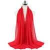 A bright red chiffon hijab scarf draped around a mannequin's neck.