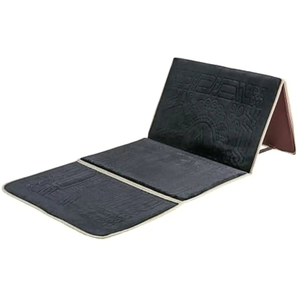 A black foldable Islamic prayer rug with a brown leather cover shown from the side.