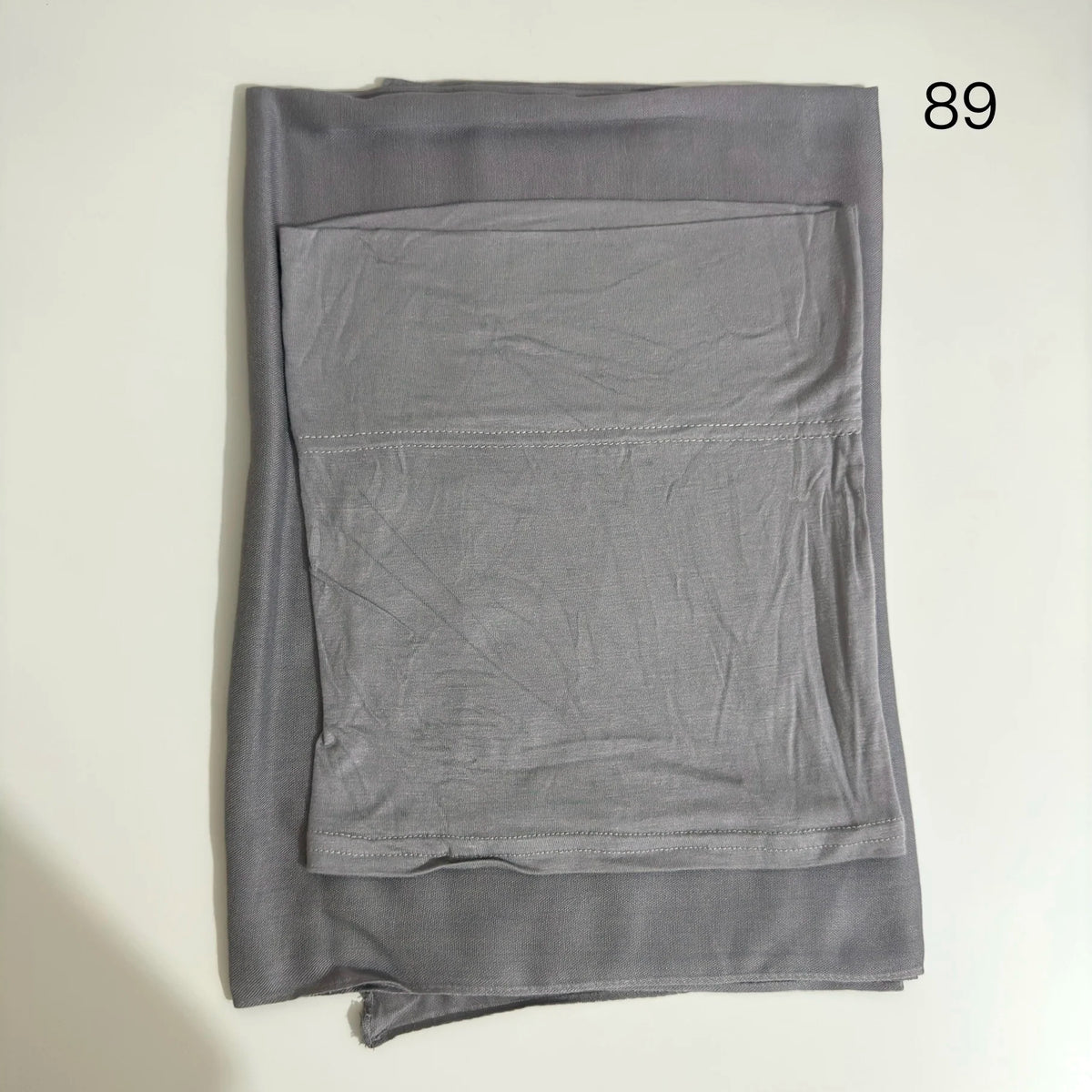 A gray soft modal rayon hijab set folded and displayed flat.
