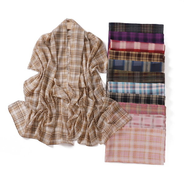 A stack of plaid print long chiffon hijab shawls in various earthy and muted tones.
