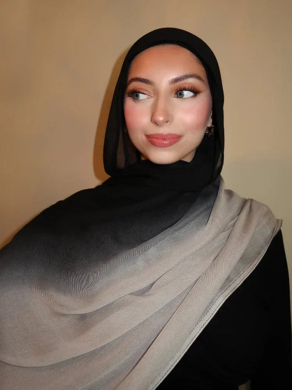 A woman wearing a gradient rayon modal hijab scarf in shades of black and gray.
